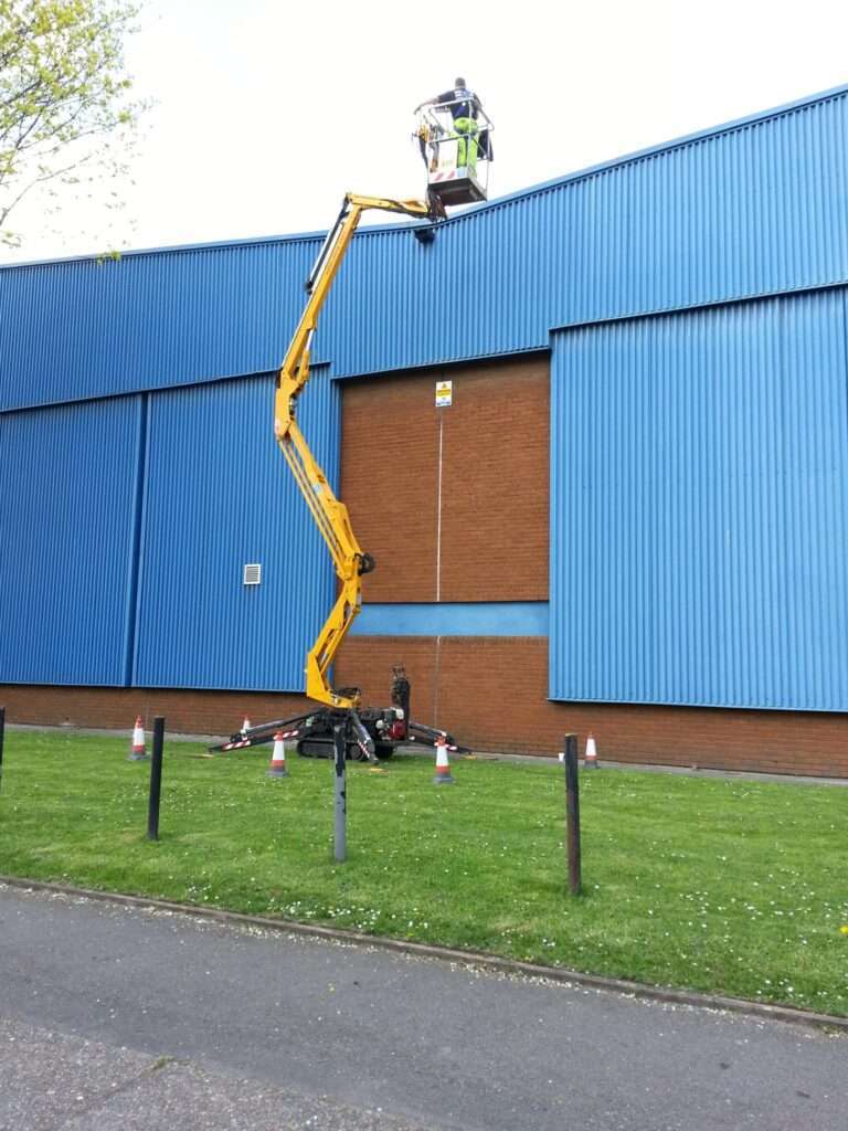 Gutter and roof drainage clean Commercial gutter cleaning at height on an industrial building